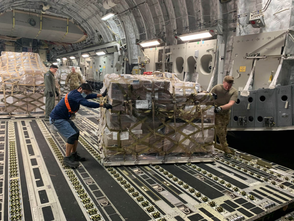 Image showing a military cargo hold with a pallet of personal protective equipment being delivered to the north mariana islands during covid-19 